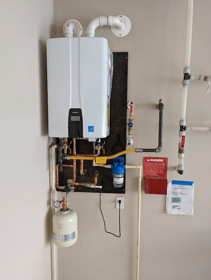 Professional plumber installing copper piping in a Sturbridge home